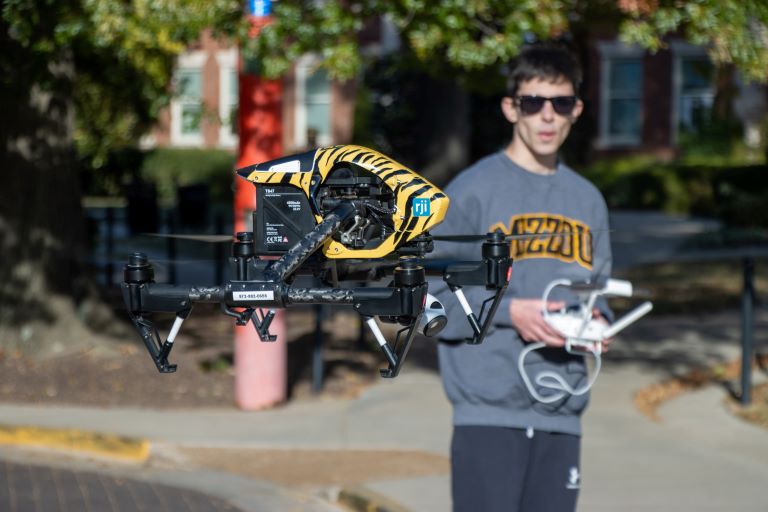 journalism student with drone technology on University of Missouri campus