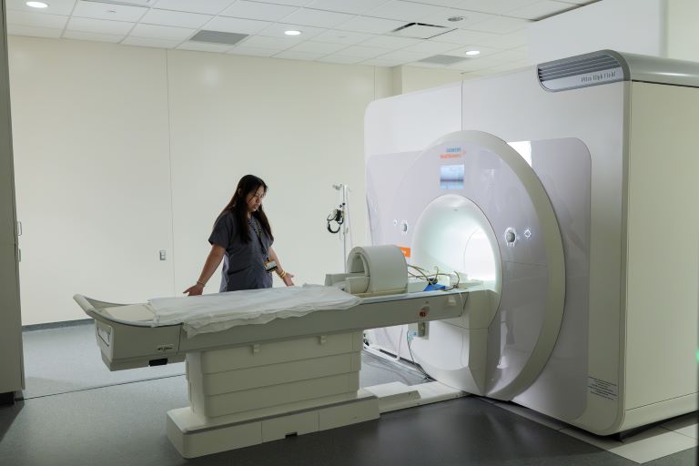 Person next to 7-Tesla magnetic resource imaging scanner (7T MRI)