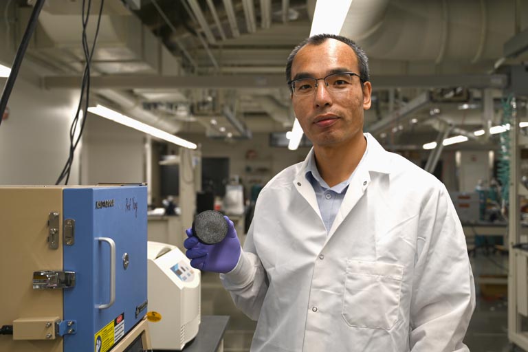 Yingchao Yang posed with biochar sample in the lab