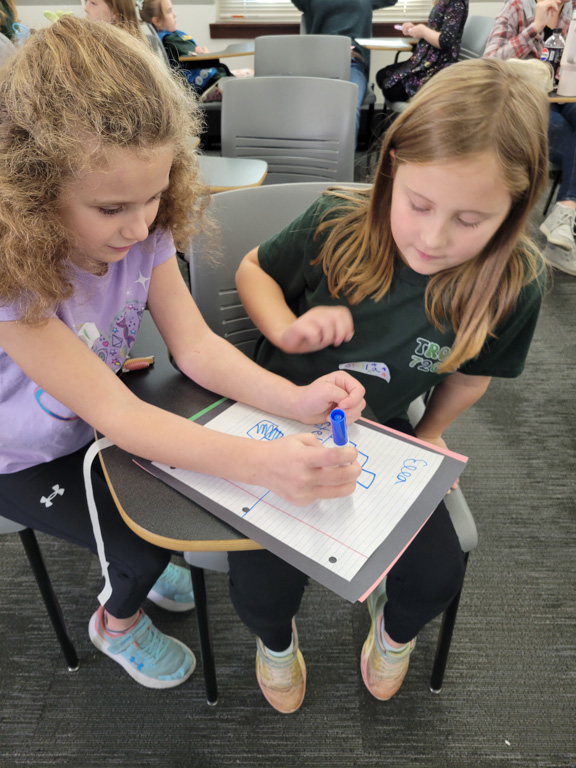 Girls doing projects at Girl Scout Day 2024