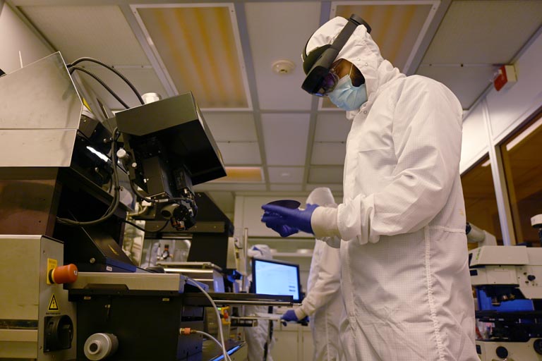 Student using machine in cleanroom