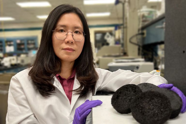 Ellen Wan with biochar panels