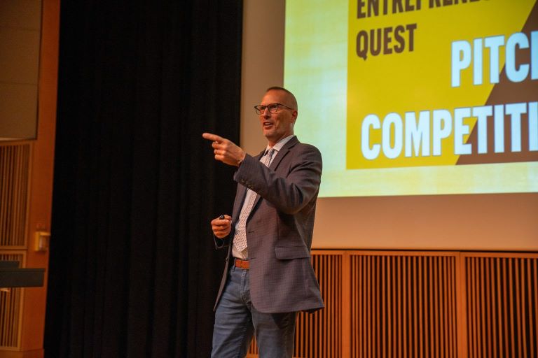 Greg Bier, executive director of entrepreneurship programs, addresses the audience at the Entrepreneur Quest finale Nov. 19.