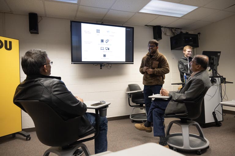 students presenting to faculty members