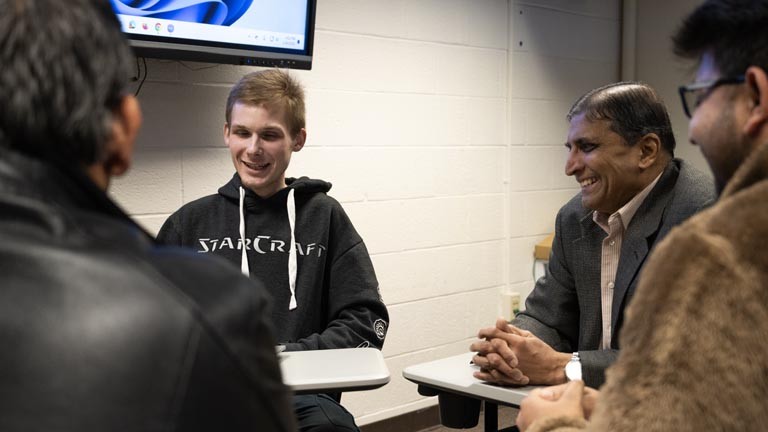 students and faculty talking