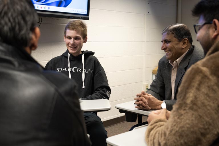 faculty and students talking