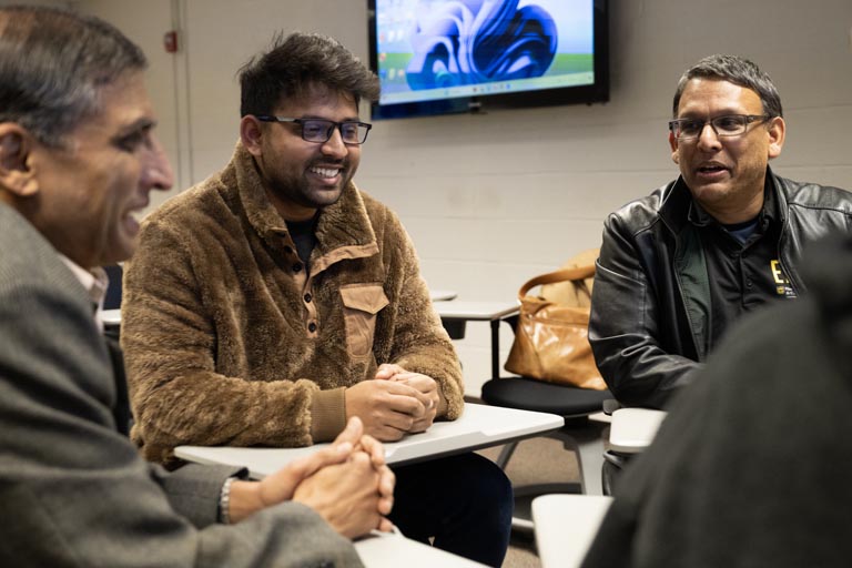 faculty and students talking