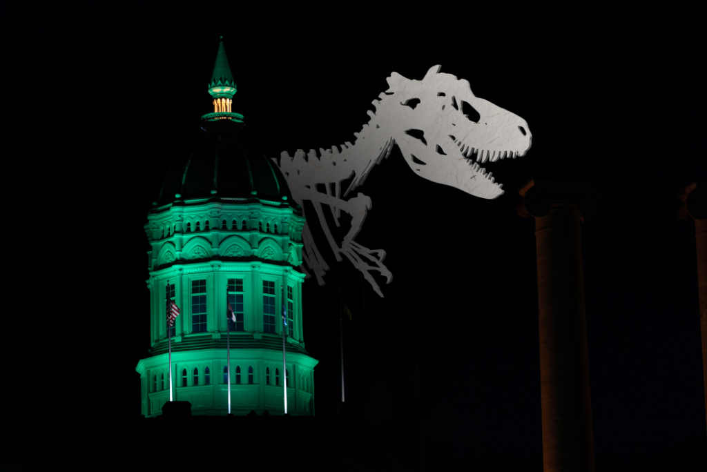 Jesse Dome lit green with dinosaur skeleton overlay