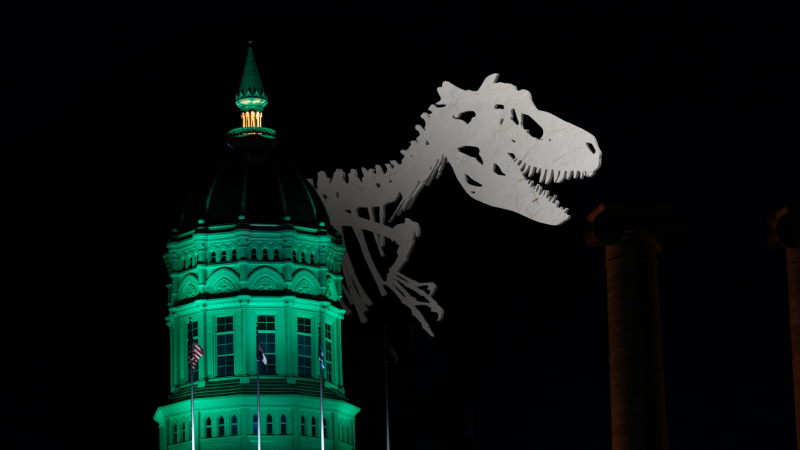 Jesse Dome lit green with dinosaur skeleton overlay