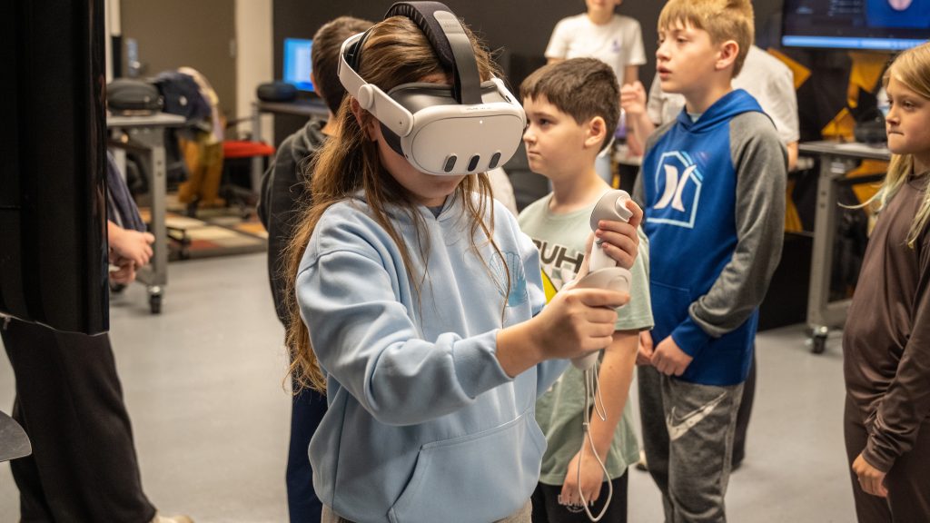 K-12 students interact with VR technology during E-Week lab exhibits