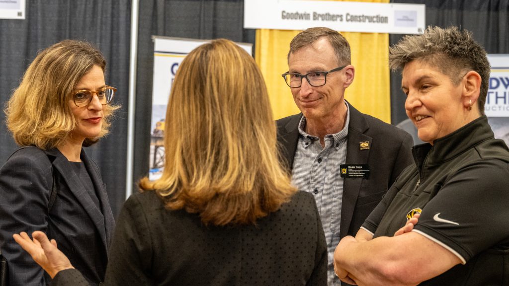 Mizzou Engineering Dean Marisa Chrysochoou, Assistant Dean Roger Fales and Assistant Vice Chancellor Meichele Foster speak with an unidentified woman at the spring 2026 career fair.