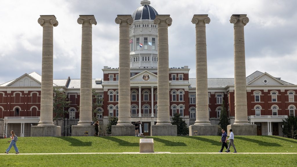 Gary Baker and Zhongyu Yang walk across Francis Quadrangle