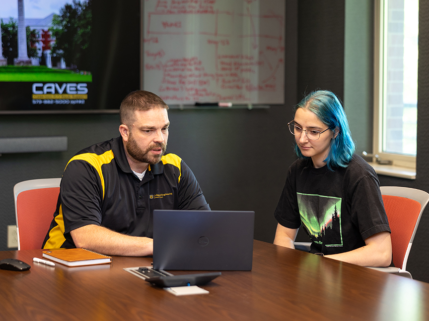 Academic advisor Justin Rich meets with a student