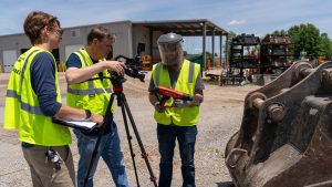 Ethan Pokress works with teammates to film content