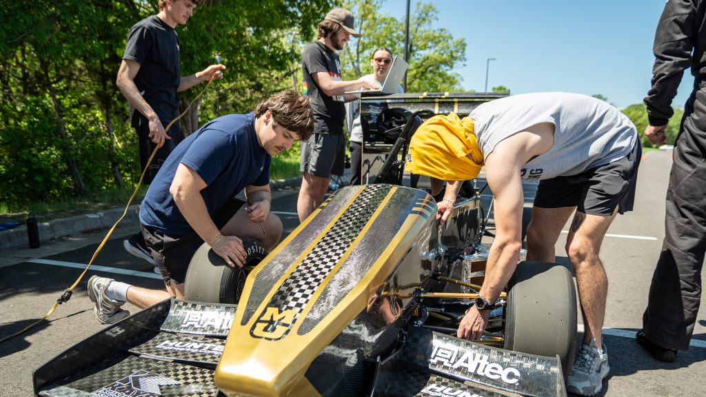 Mizzou Racing team members work on their race car.