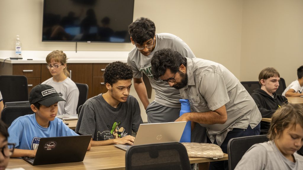 Roshan Neupane and Aneesh Calyam showed middle and high school students how to use coding and tools to detect cyberattacks.