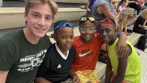 Four young men smile and pose for a group photo