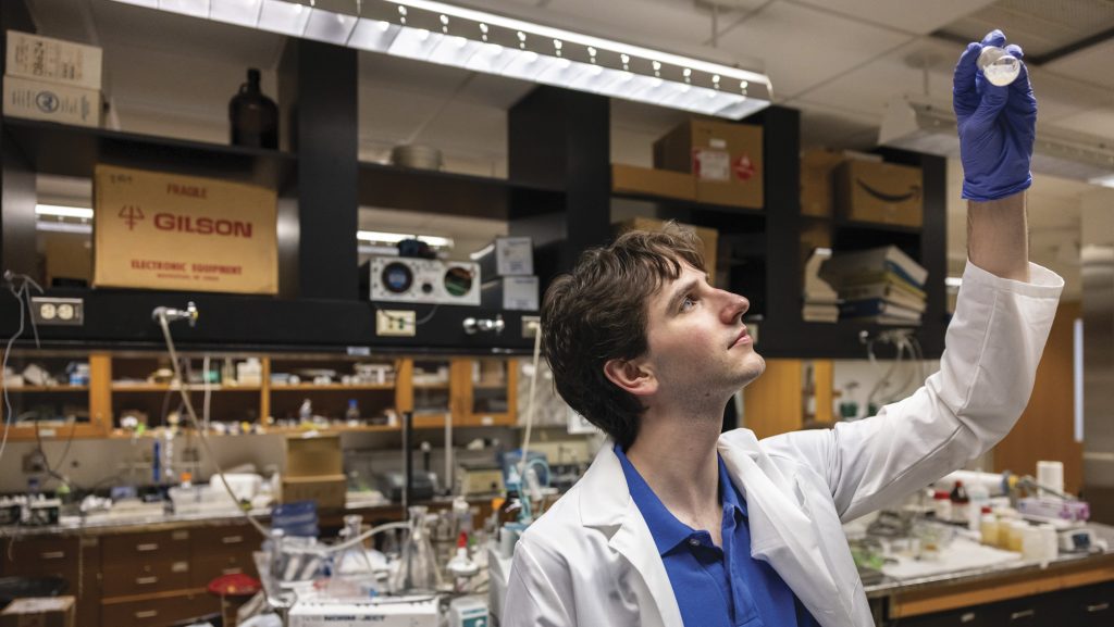Josh Donaldson examines a water sample in the lab.