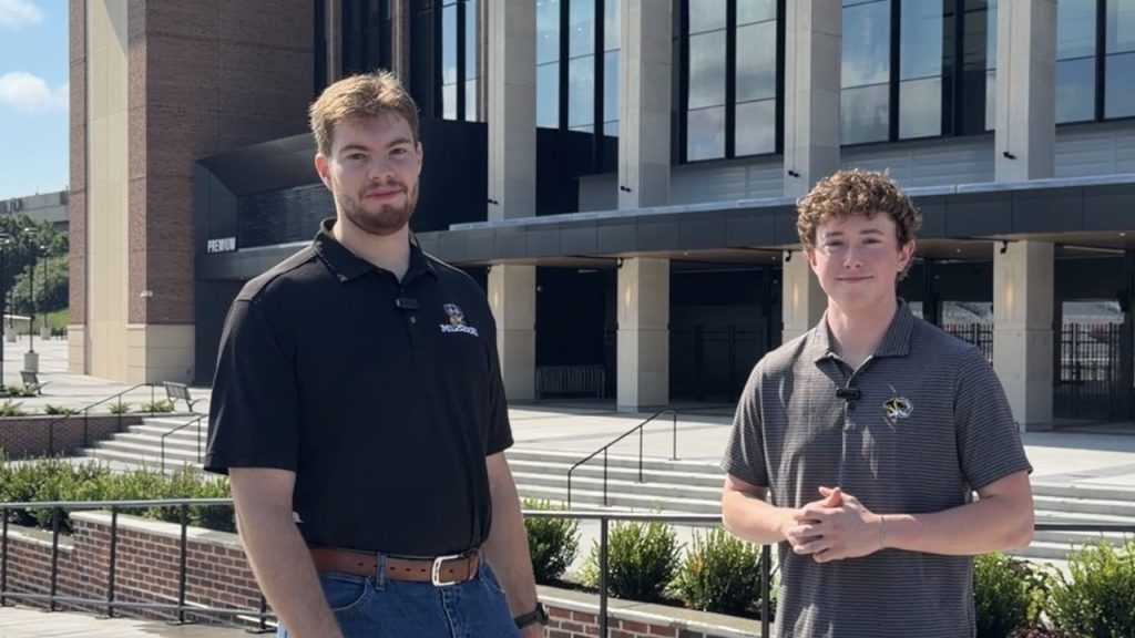 Will Benson and Connor McNaughton stand in front of the renovated north end of Memorial Stadium