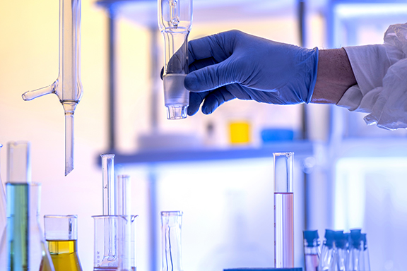 Hand holds a glass rectification fractionating column