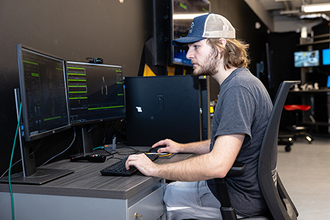 Man works on a computer in a lab
