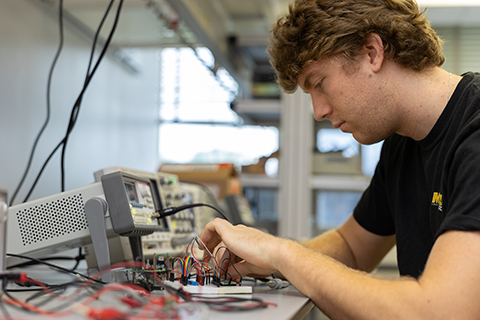 A man works on computer materials