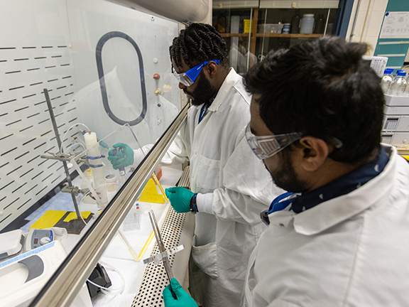 Two men work in a lab in MURR