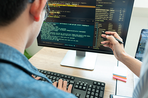 Hand gestures at code at a computer screen