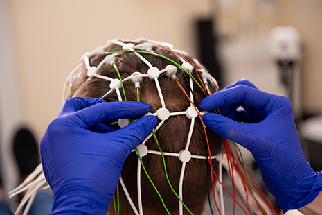 Patient brain testing using encephalography at medical center.