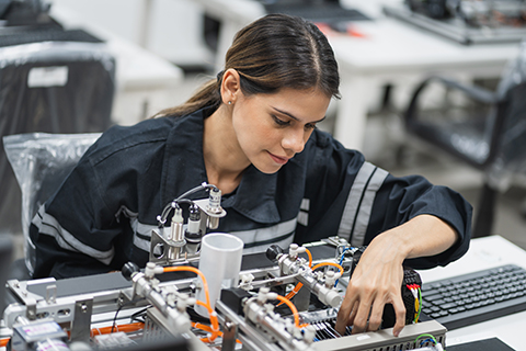 Woman works on the interior of a computer