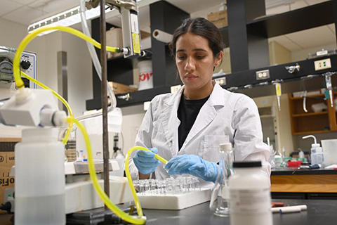Woman works on water in a lab
