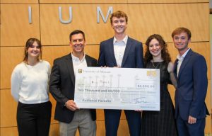 ProxiPatch team accepts an oversized check from Hawthorn Bank banker Mike Moran.
